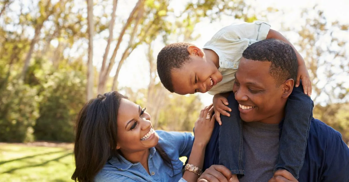 father carries son on shoulders and talks with wife on Veneers vs invisalign