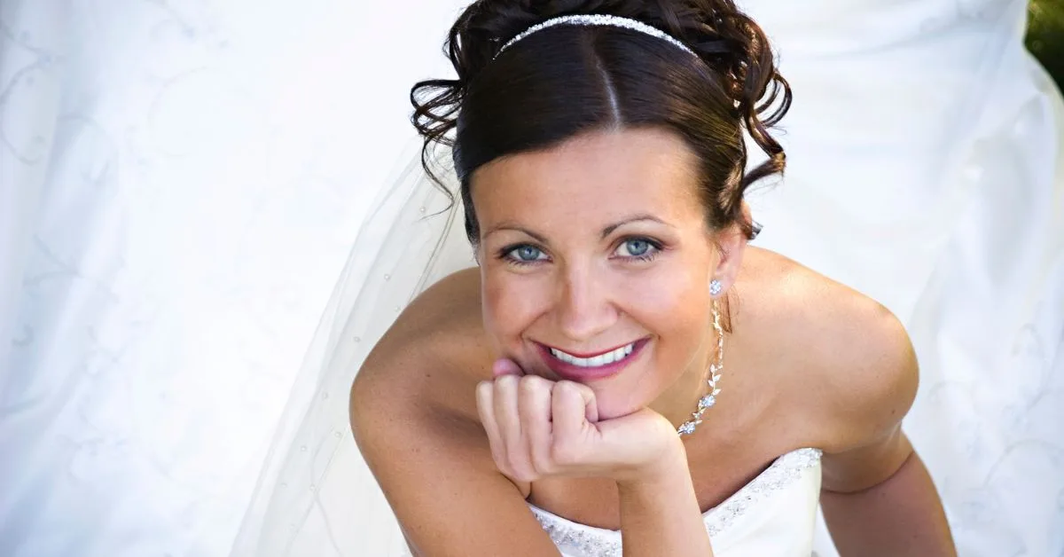 bride smiles in her wedding dress after she learns the fastest way to straighten teeth before wedding
